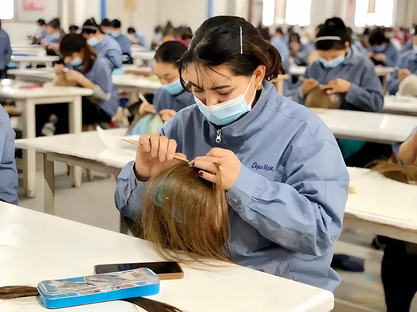 Professional raw human hair wig manufacturing workshop with skilled workers